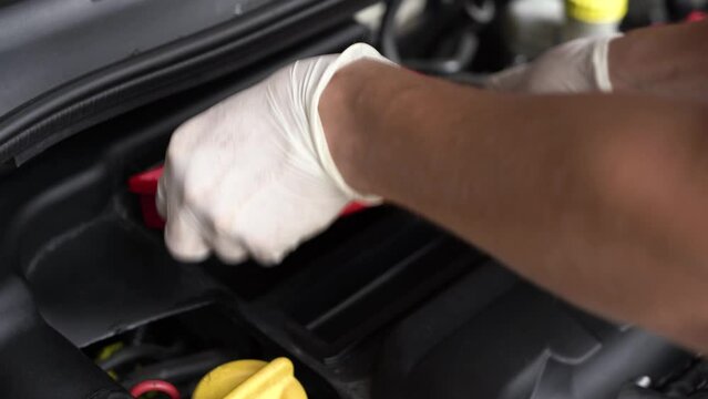 auto mechanic replaces parts. car service. close-up.
