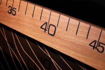 close-up of a wooden ruler on a black background