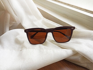 Brown polarized sunglasses on the bed