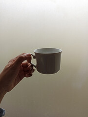 hand holding a cup of coffee