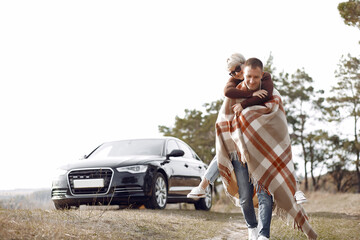 Fototapeta premium Beautiful couple spend time on a autumn field