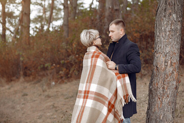 Beautiful couple spend time on a autumn field