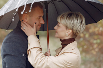 Beautiful couple spend time on a autumn field