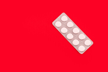 Medicines in packaging on a red background. Flatlay. women's health, treatment, therapy,...