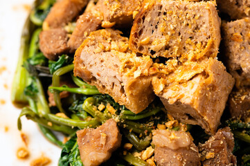 Adobong Kangkong (Water spinach) topped with fried tofu and pork sprinkled with toasted garlic bits