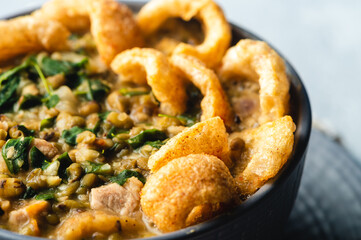 Ginisang Munggo at Chicharon is a famous Filipino dish and is a delicious mung bean stew flavored with crispy pork cracklings.