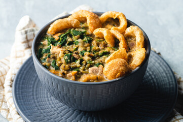 Ginisang Munggo at Chicharon is a famous Filipino dish and is a delicious mung bean stew flavored with crispy pork cracklings.
