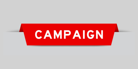 Red color inserted label with word campaign on gray background