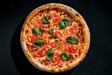 Delicious fragrant pizza with mozzarella, tomatoes and basil with tomato sauce - Margherita