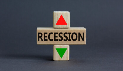 Recession up or down symbol. Concept word Recession and up and down arrow on wooden blocks on a...
