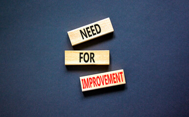 Need for improvement and support symbol. Concept words Need for improvement on wooden blocks. Beautiful black table black background. Business, need for improvement quote concept. Copy space.