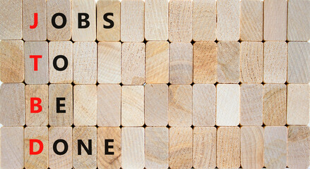JTBD jobs to be done symbol. Concept words JTBD jobs to be done on wooden blocks on beautiful wooden background. Business and JTBD jobs to be done concept. Copy space.