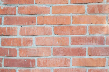 Brick wall of a house as a background, red bricks as texture close-up