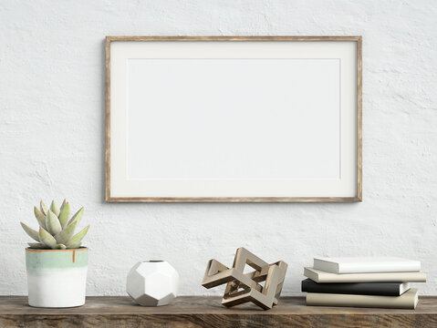 Mock up poster frame on white plaster wall with echeveria plant in a pot, books and geometric object on old wooden table; landscape orientation; stylish frame mock up; 3d rendering, 3d illustration