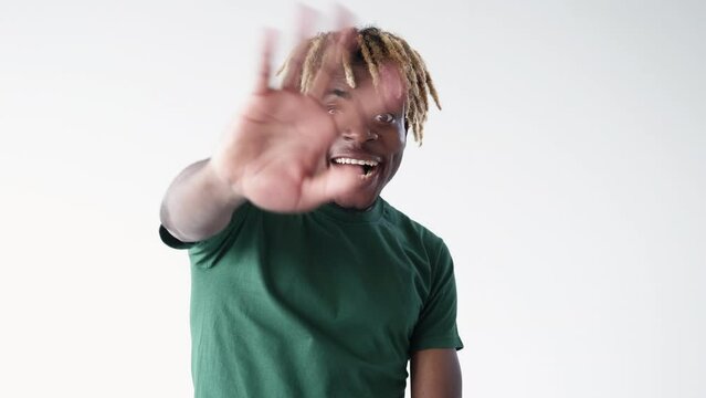 Expressive happiness. Greeting man. Meme expression. Excited black guy waving hands feeling joy to meet friends isolated white looped video.