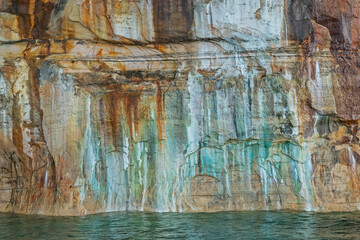 Abstract landscape of a mineral stained cliff along the eroded sandstone shoreline of Lake Superior, Pictured Rocks National Lakeshore, Michigan’s Upper Peninsula, USA