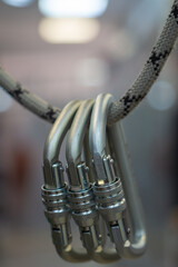 Alot of steel carabiners for industrial use hangs on a static rope