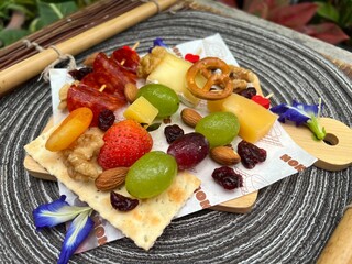 Cheese board with cold cuts fruit and mixed nuts