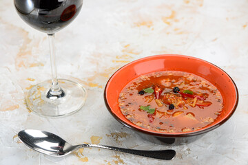 pickle in an orange plate with olives
