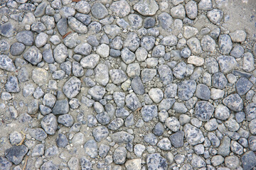 Dusty dirty pebble rocks on the ground