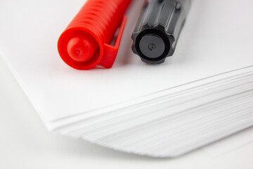 Markers on white paper. Red and black marker. Stationery.