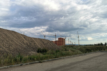 Obraz premium view of construction site and tower crane