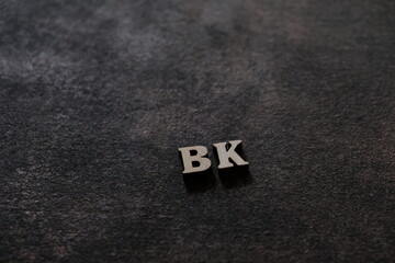 The letters B and K above the dark field. Initials BK