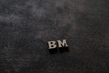 The letters B and M above the dark field. Initials BM
