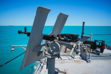 Automated machine gun on the deck of a military ship