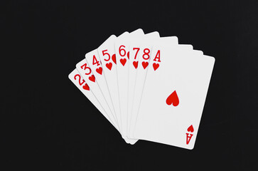 Royal Flush playing cards on a black background.