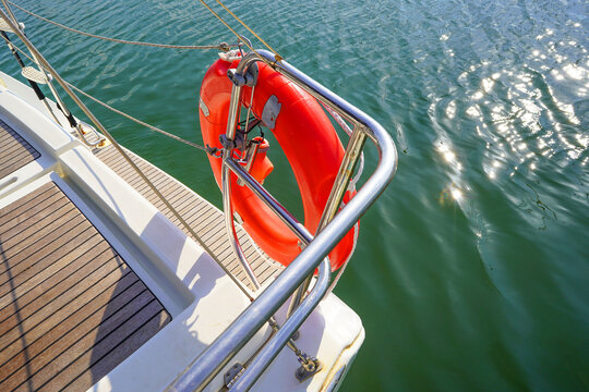Lifebuoy aboard a yacht. Sailing boat wide angle view in the sea. Yachting as a luxury sport and great vacation