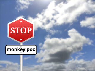 Stop monkey pox sigh board on blur sky background.