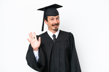 Young university graduate man isolated on white background saluting with hand with happy expression