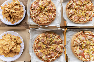 Group of male and female colleagues having pizza lunch together at the office after work celebration concept
