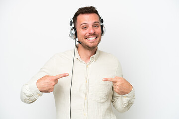 Telemarketer caucasian man working with a headset isolated on white background proud and self-satisfied