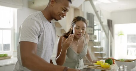 Cooking food, making dinner or preparing a meal with a happy, in love and healthy young couple. Man and woman in the kitchen, smiling while smelling the dish made and adding seasoning or flavor