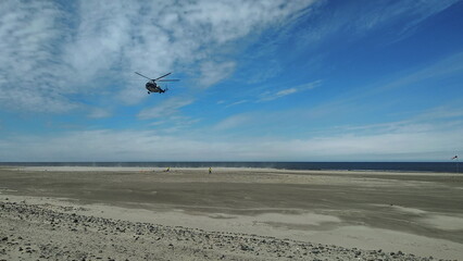 Mi-8 helicopter landing in the Arctic tundra on the coast of the Barents Sea. Varandey, Russia.