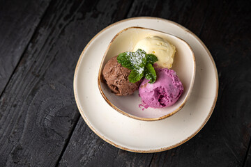 ice cream with chocolate and mint on a wooden background.
