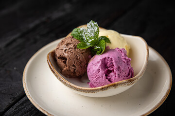 ice cream with chocolate and mint on a wooden background.