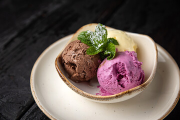 ice cream with chocolate and mint on a wooden background.