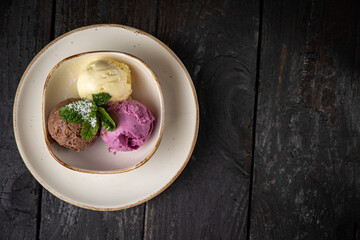 ice cream with chocolate and mint on a wooden background.