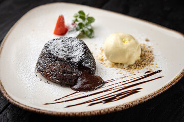 chocolate cake with cream on a wooden background