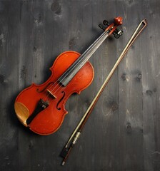 Plakat violin and bow on black wooden background