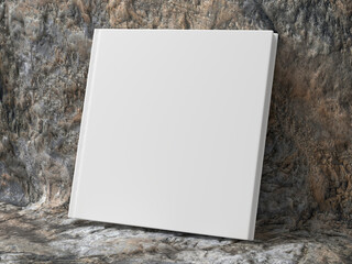 Blank square hardcover book cover mockup standing on stone background