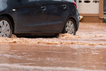 Driving through flood water, flooded car