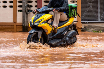 Riding a motorcycle through a flooded vehicle