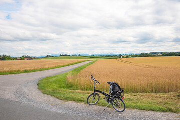 Fototapeta na wymiar bicycle tour with small folding bike, around the fields near Ebersberg, cloudy day
