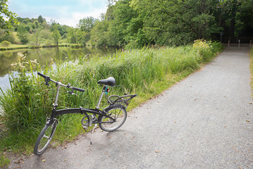 Fototapeta na wymiar bicycle tour with small folding bike, along aline of ponds near Ebersberg, called Weiherkette