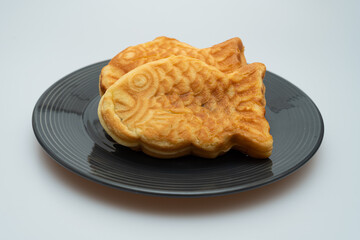 Sweet red bean bread in the shape of a crucian carp in a bowl