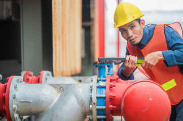 Asian man engineer are working in factory and checking safety system control on production industrial